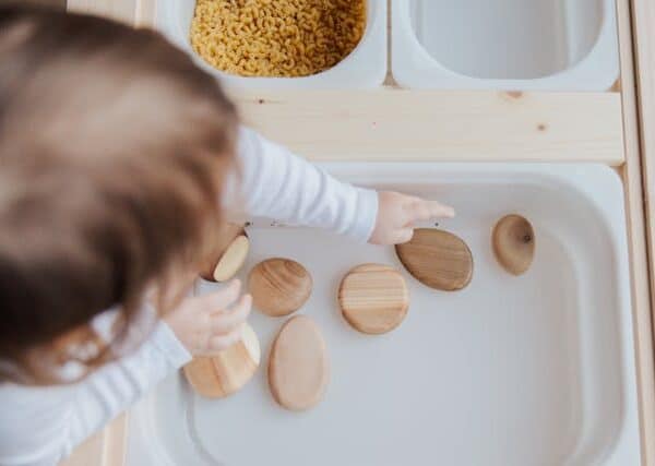 toddler playing wooden toys