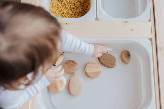 toddler playing wooden toys